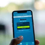 Mobile phone displaying Betano registration page on a browser interface